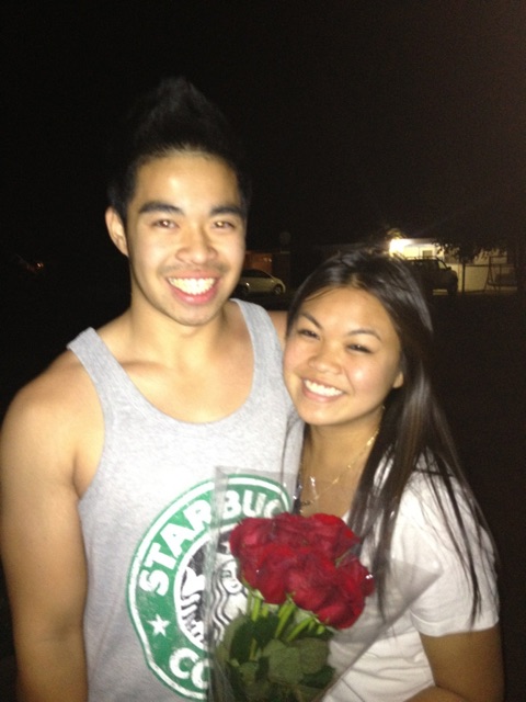 Debra and Vinh's first photo together, Debra holding a bouquet of red roses