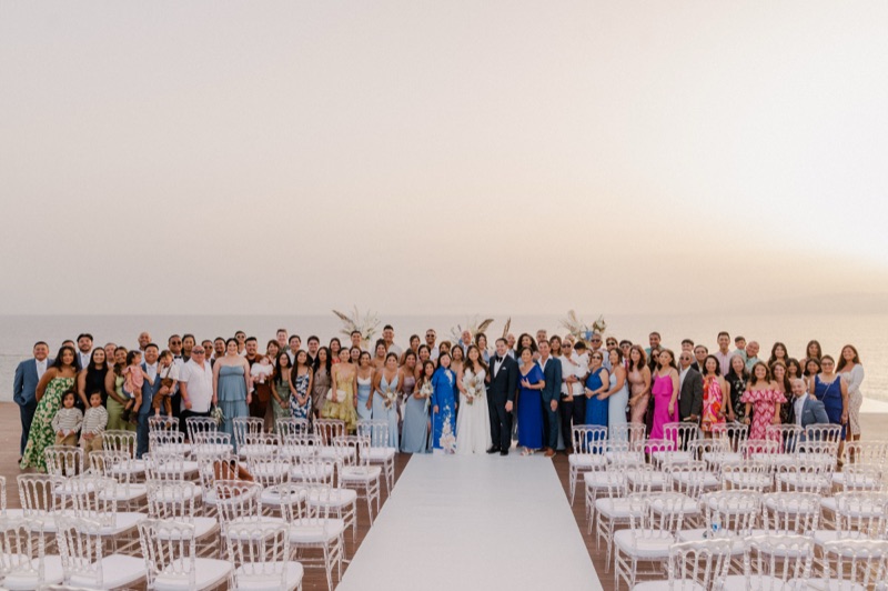 Wedding guests gathered around Debra and Vinh at their oceanside ceremony in Tenerife